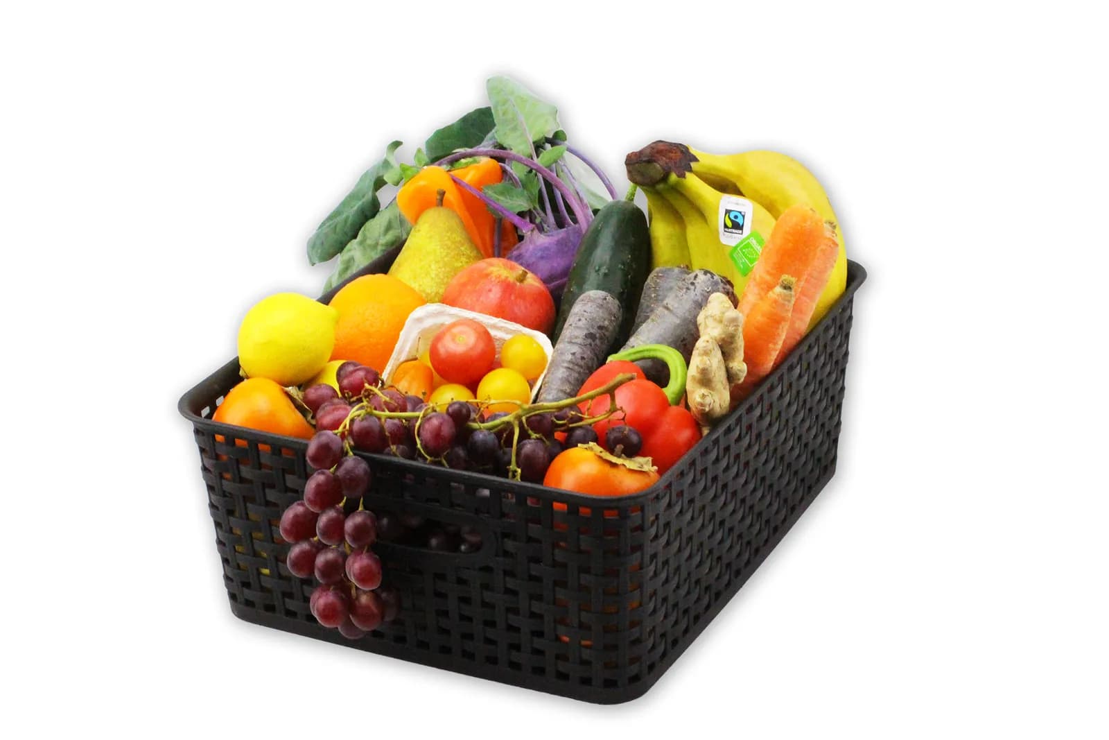 Bio-Obstkorb fürs Büro mit Bananen, Äpfeln, Birne, Trauben, Zitrusfrüchten und Snackgemüse wie Möhren, Gurke, Paprika und Kohlrabi